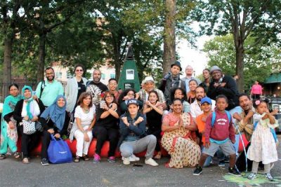 The event organizers and participating organizations and local businesses band together for a group photo crossing their arms in a proud X for the Bronx.