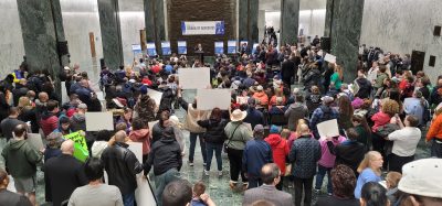 Crowd of people holding up signs at a Disability Advocates rally in Albany